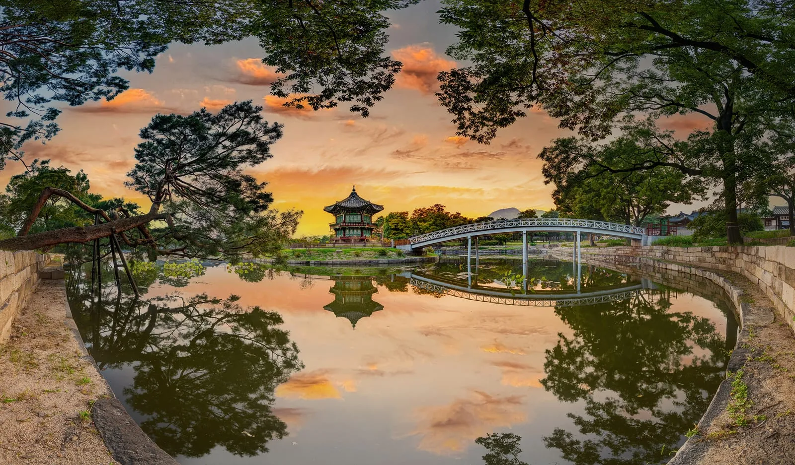 Hyangwonjeong Pavilion and its bridge reflected in the pond at sunset, Gyeongbokgung