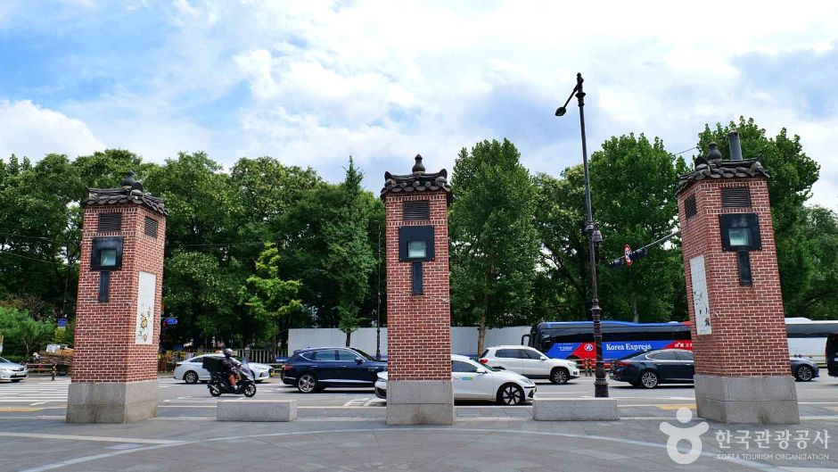 Brick gateposts marking the entrance to the Insadong district with traffic behind